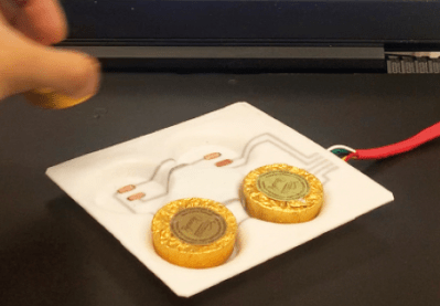 plastic tray with electrodes to sense foil wrapped chocolates