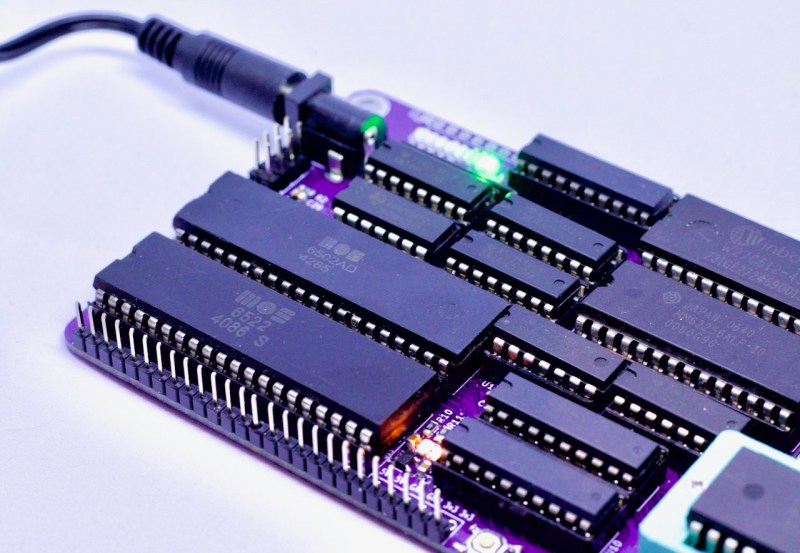 A purple PCB with many DIP chips including a 6502