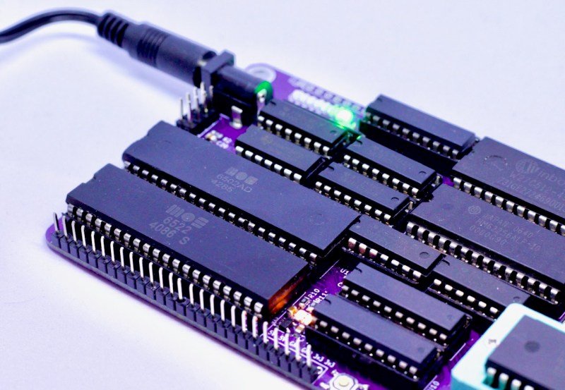 A purple PCB with many DIP chips including a 6502