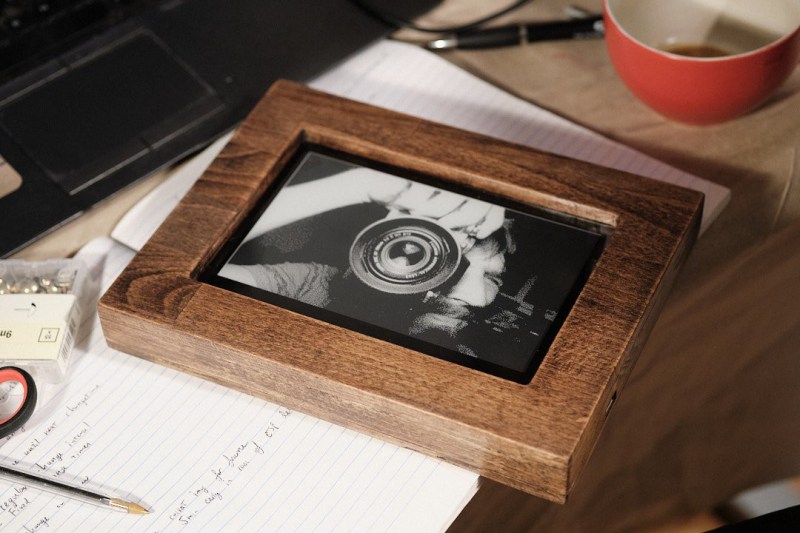 A wooden picture frame with an e-ink display