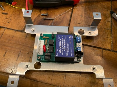 An OpenEVSE controller mounted on a bracket