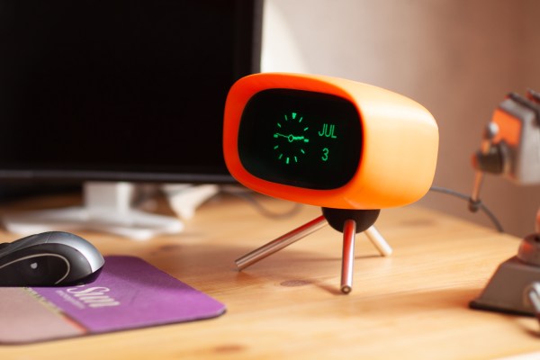 A clock with a VFD display in an orange TV-like case