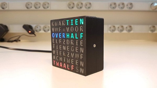 The word clock on a desk, with "tien", "over", "half" and "twaalf" lit