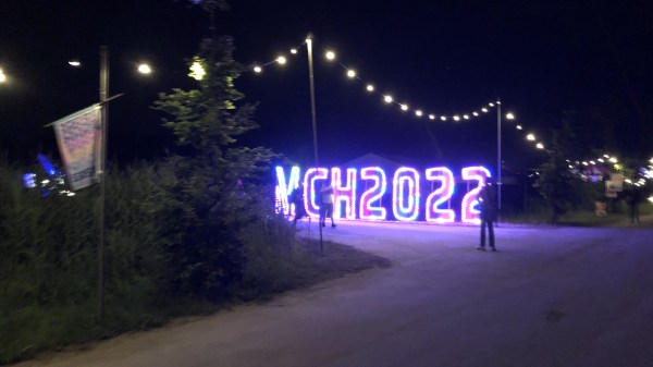 An illuminated MCH2022 sign composed of large LED letters