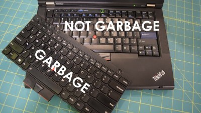 A Youtube thumbnail showing a Thinpad in the background with "Not Garbage" written over its keyboard, and one more keyboard overlaid onto the picture with "garbage" written on that one.