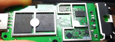 The modem with its cover taken off, showing the chips on its board.