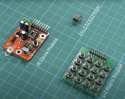 Infrared transmitter/receiver cloner board with a 4x4 pushbutton board next to it and an EEPROM above them both