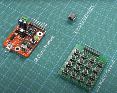 Infrared transmitter/receiver cloner board with a 4x4 pushbutton board next to it and an EEPROM above them both