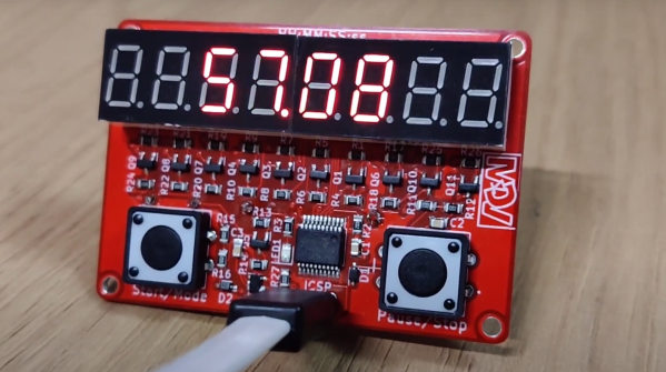 Simple Stopwatch with two buttons, an eight digit 7-segment display and ICSP programming cable going into the board