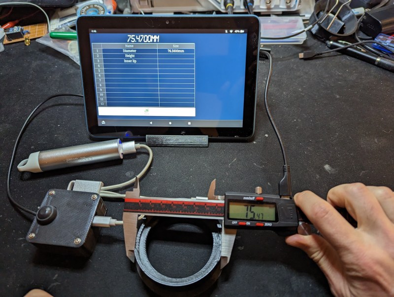 A digital caliper connected to a tablet computer