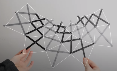 a kinetic bar framework with 3d printed bars of alternative black and grey color, each joined with m3 bolts and nuts being held by a person at two points with a quadrilateral tiling overlay