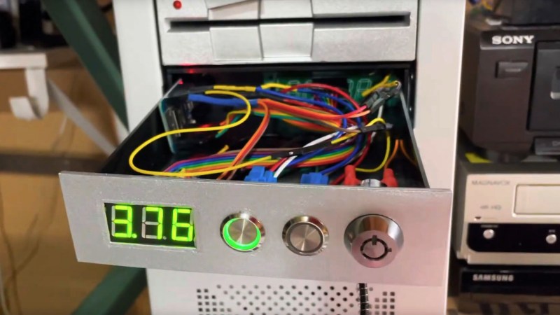 A personal computer drive bay with a glowing LED display