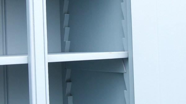 A blue cabinet. Inside, along the front and back are wooden sawteeth holding a cleat. On the cleat sits the shelf itself.