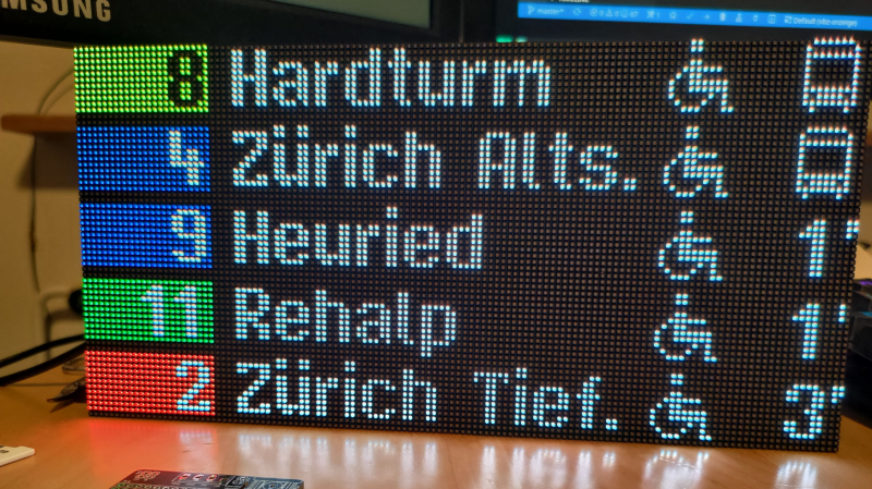 an RGB LED display showing expected arrival times of trams and buses sitting on a table