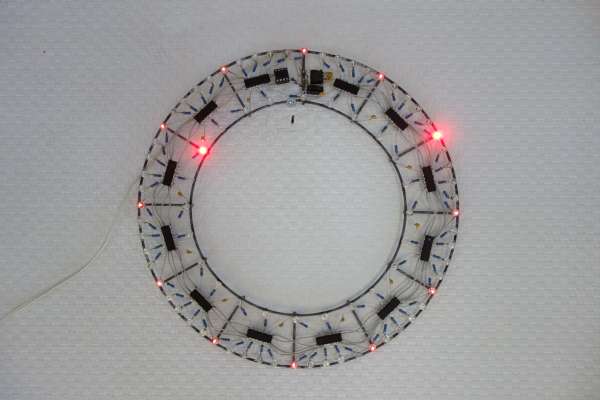 A wall clock made from wires and electronic components