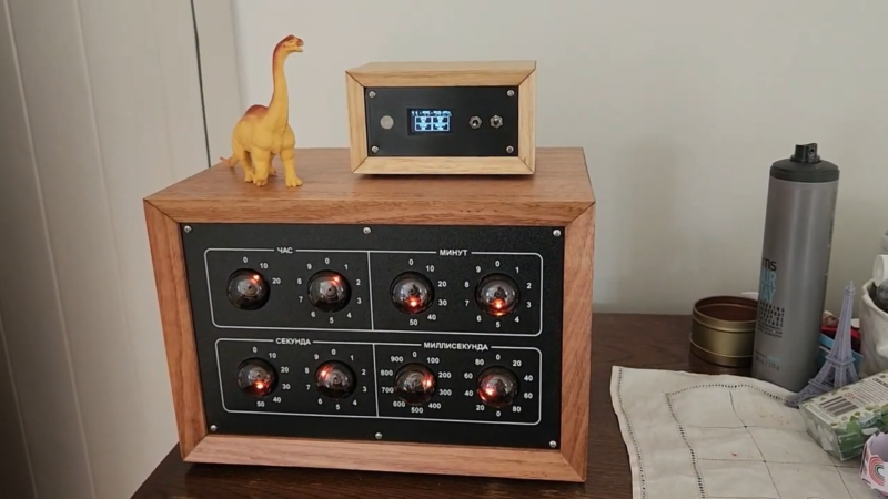 A dekatron-based clock with a GPS receiver and a plastic dinosaur on top