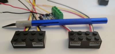 Two imitation LEGO bricks with electronics inside