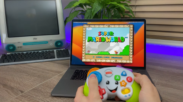 A toy gamepad controlling Super Mario World emulated on a MacBook