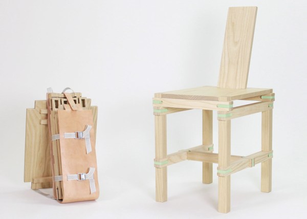 A simple wooden chair with mint metallic connectors at the corners sits next to a pile of wooden pieces wrapped in leather and straps to form a backpack.
