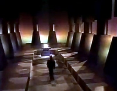A still from the Amiga 1000 launch advert in 1985, a man walking down a pillared hall towards a distant computer on a pedestal.