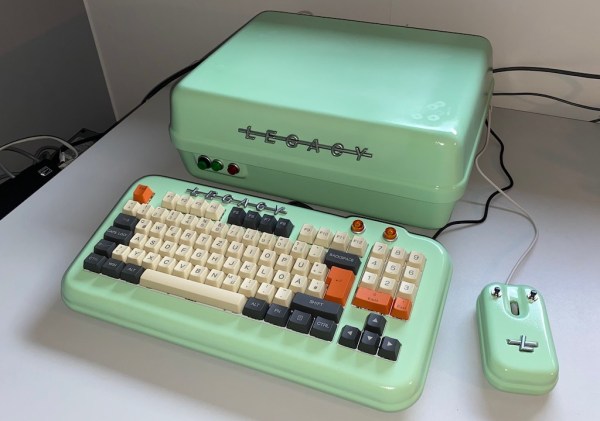 Showing the vintage PC, painted in 50s color scheme, matching custom-built keyboard and mouse next to it