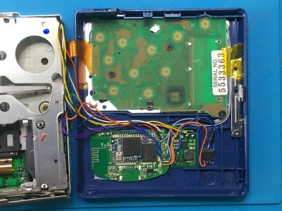 A MiniDisc Walkman, opened up and showing a BlueTooth module inside