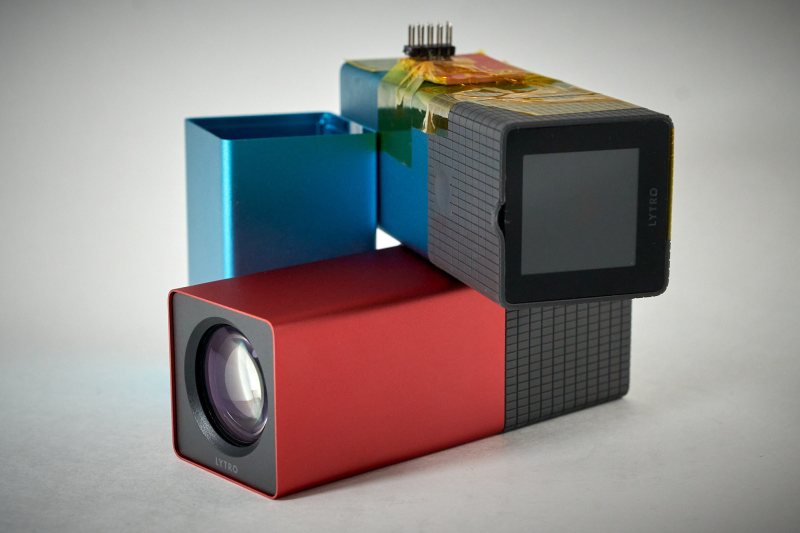 A red and blue Lytro camera with a serial port soldered onto one