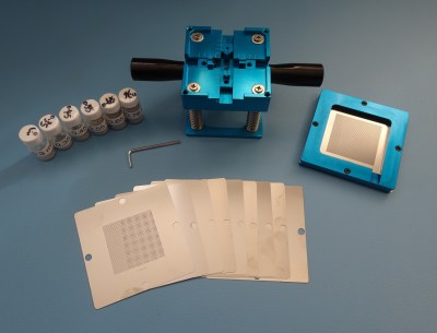 A BGA reballing jig with a set of stencils and a supply of solder balls