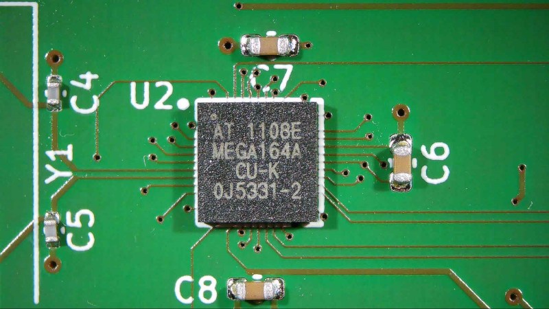 A PCB with an ATmega164 and a few capacitors