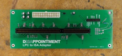 A green PCB with an ISA card slot and various connectors and components. The text "DISAPPOINTMENT LPC to ISA Adapter" is printed in the bottom left of the board.