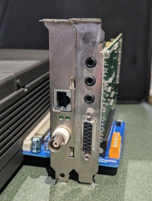 An expansion board plugged into a laptop, carrying two ISA cards