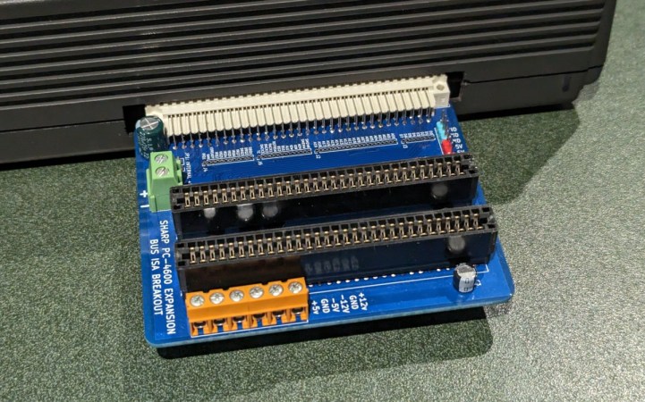 An expansion board with two 8-bit ISA slots plugged into a Sharp laptop