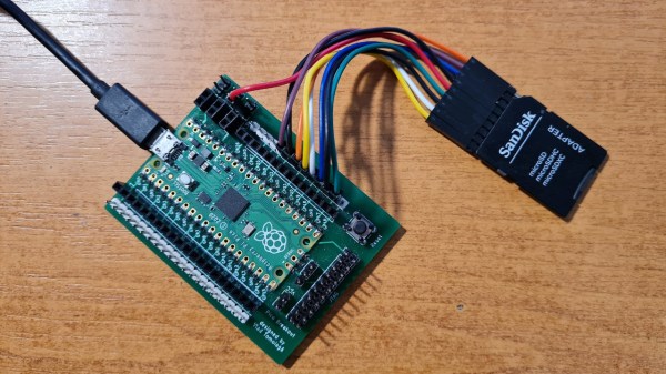 A Pi Pico soldered onto a custom breakout PCB, with an SD card connected to it using prototyping wires