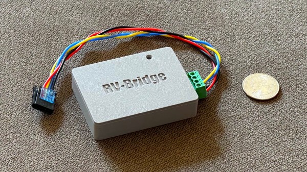 A gray 3d-printed box with RV-bridge embossed on it, and a connector-terminated bundle of wires coming out of it.