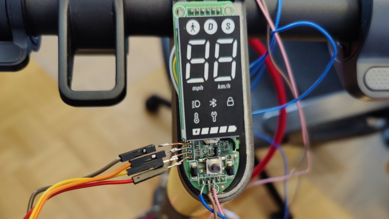 A Xiaomi 3 Lite dashboard with the panel taken off and the PCB visible, four wires connected to the SWD header.