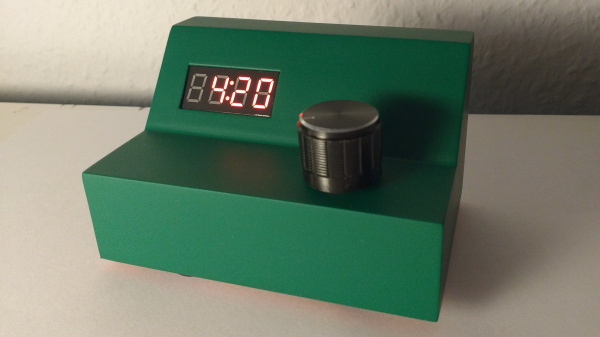 Kitchen timer project in a angled green 3d printed case with a 7 segment display and knob.