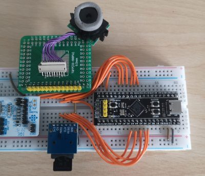 A camera module and an STM32 module on a solderless breadboard