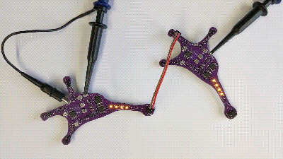 Two neuron-shaped PCBs exchanging signals