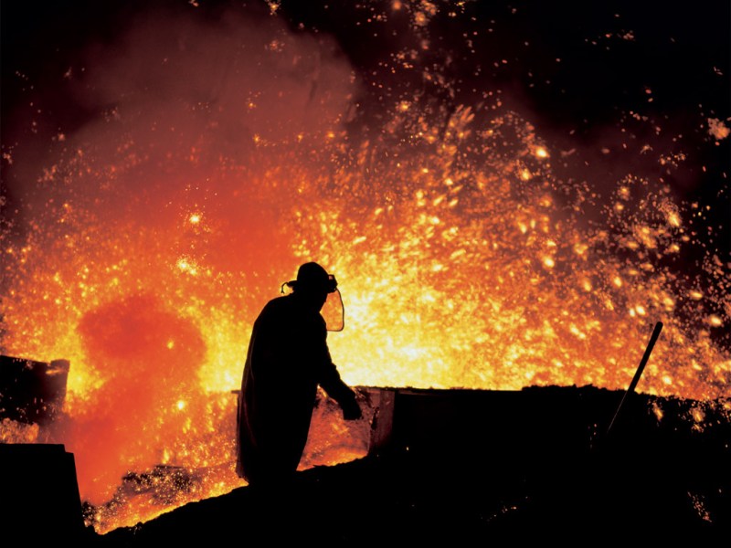 Metallurgist working by the blast furnaces in Třinec Iron and Steel Works. (Credit: Třinecké železárny)