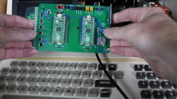 One of the PCB projects involved being held in the author's hands - a large-ish green board, with two Pi Picos visible on it