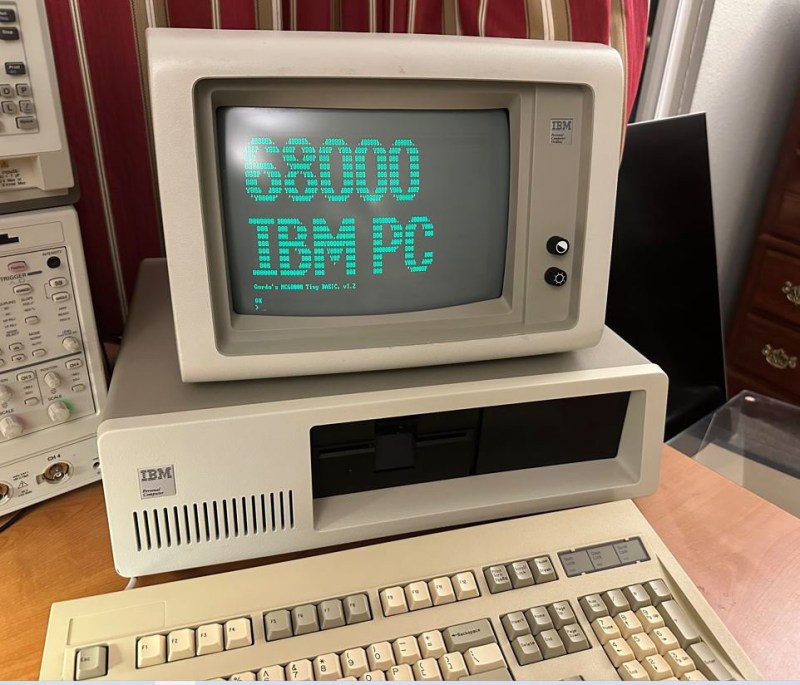 An IBM PC showing "68000 IBM PC" on its monitor