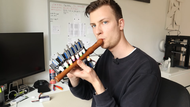 A man playing an automated recorder
