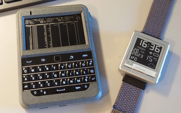 A BlackBerry Classic-sized device with a BlackBerry keyboard and an e-ink screen. It sits next to an e-ink smartwatch with a grey bezel that matches the 3d printed enclosure of the messaging device.