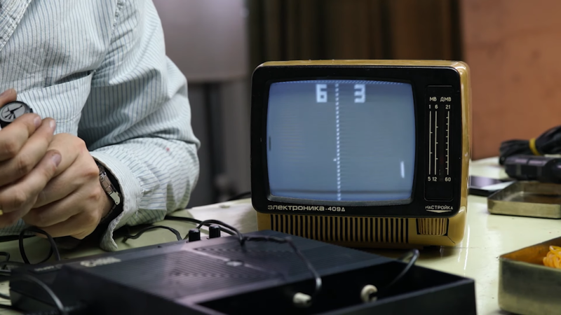 A small B/W TV showing a Pong-like game being played on a Soviet-era game console