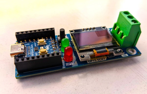 A PCB with an OLED display, a screw terminal block and a Raspberry Pi Zero board