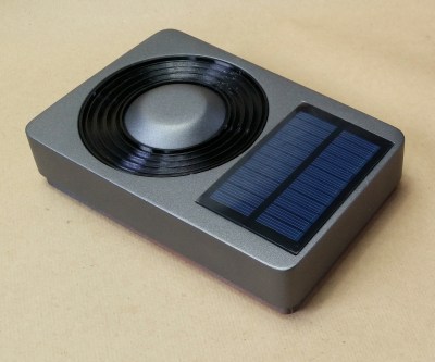 A speaker's passive radiator next to a solar panel
