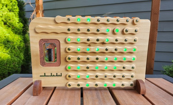 A wooden frame with 64 green LEDs running a Game of Life simulation