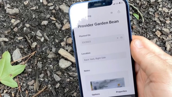 Mobile phone reading an NFC tag with information on a garden plant