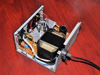 A power supply with the lid removed, visible is a large transformer