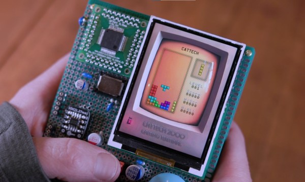 A handheld computer made on a piece of prototyping board running a Tetris clone